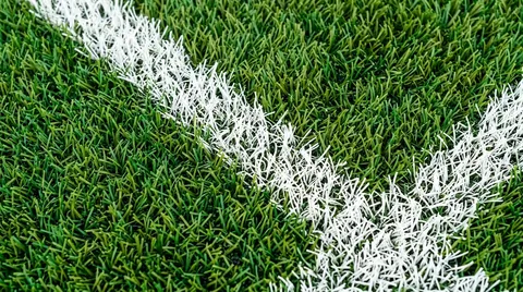 Despliegue y tendido milimétrico de rollos de césped sintético monofilamento con orientación técnica de fibra en obra deportiva
